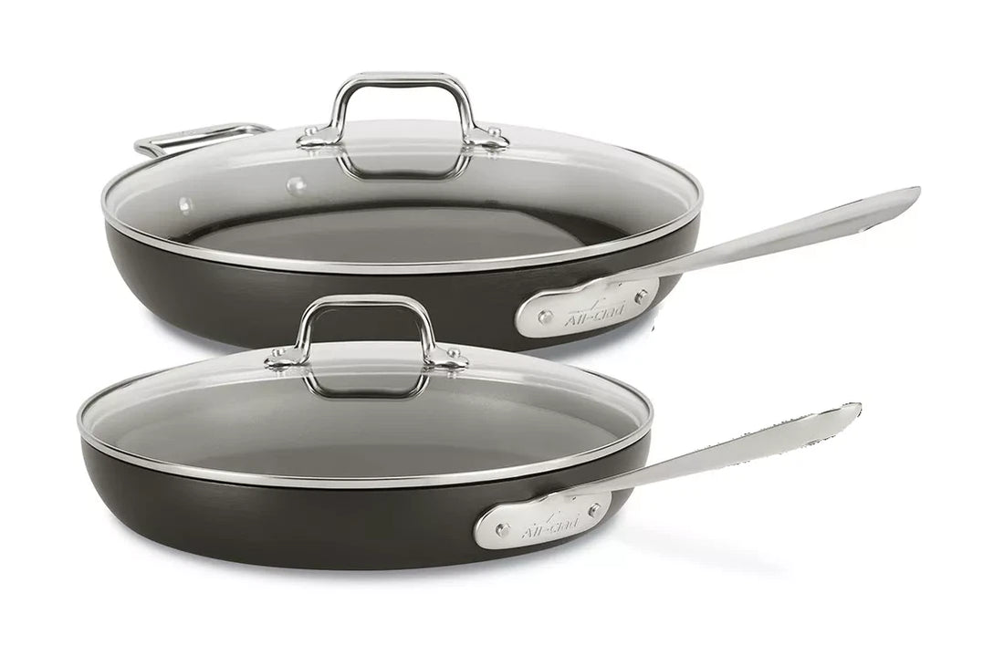 All-Clad HA1 10 and 12 inch hard anodized nonstick fry pans with matching lids on white background