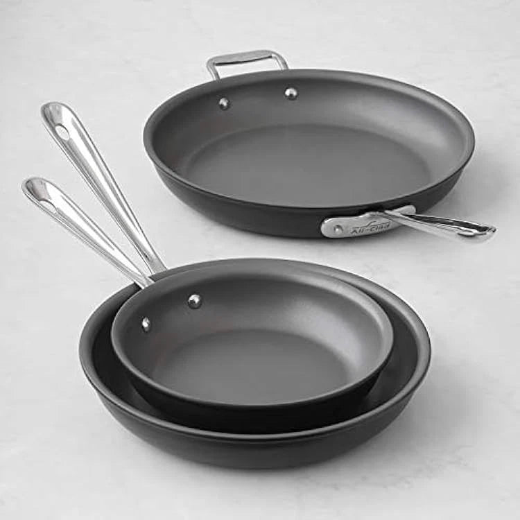All-Clad NS1 nonstick 8-inch 10-inch and 12-inch fry pans displayed together on a kitchen surface