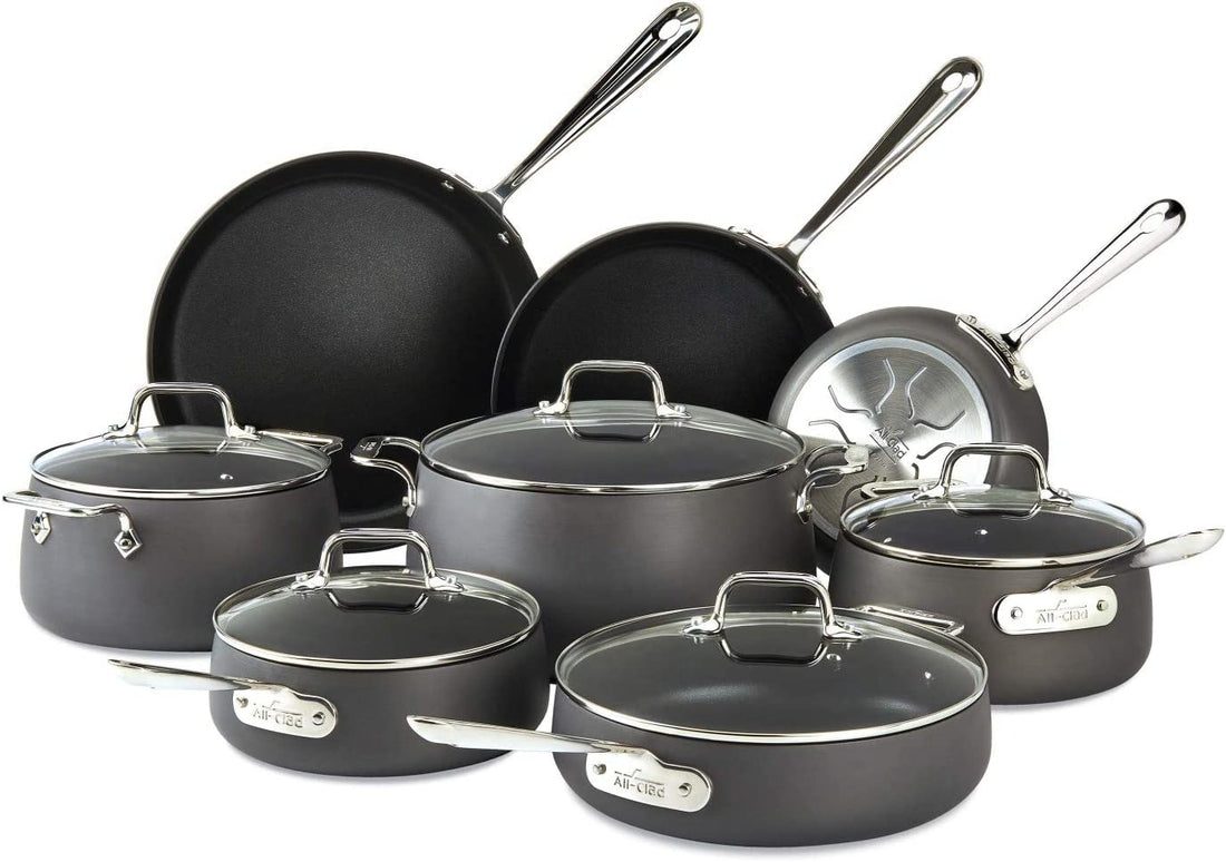 All-Clad HA1 E100SB64 13-piece nonstick cookware set with fry pans, saucepans, sauté pan, soup pot, and stockpot on white